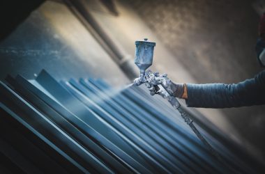 man painting metal products with a spray gun man painting metal products with a spray gun