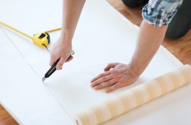 close up of male hands cutting wallpaper close up of male hands cutting wallpaper